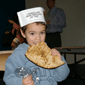 A young baker takes a hearty bite off his own crunchy Matza on his way out of the Museum